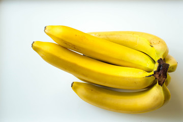 Group of ripe bananas on a white background. The view from the top.