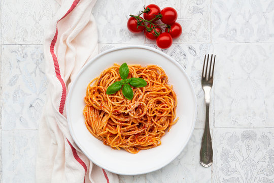 Plate of spaghetti with tomato sauce, Parmesan cheese and basil