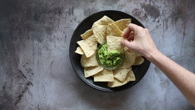 Dipping a Tortilla Chip into Guacamole 