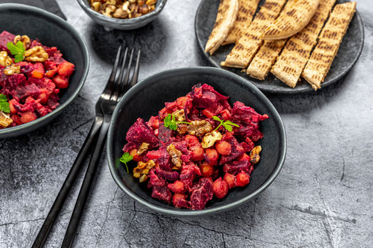 Pita bread and plates of beetroot salad with chick-peas, roasted walnuts and parsley