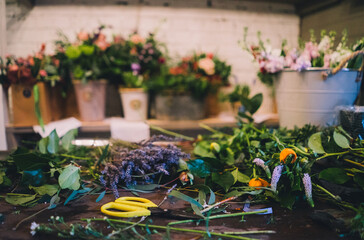 Fototapeta premium Flowers in Florist Shop with bouquets, potted plants and garden accessories