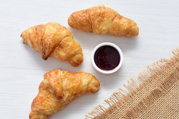 Small butter croissant, accompanied by blackberry jam