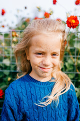 Portrait of young beautiful girl stands in the garden