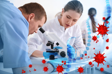 Scientists using modern microscope at table in laboratory. Researching of virus