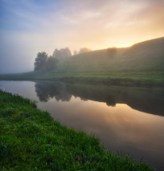 Dawn in the river valley. morning fog
