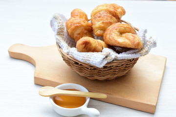 Small butter croissant, accompanied by honey