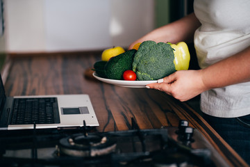 Overweight woman recording video cooking healthy food at home kitchen. Cooking recipe online...