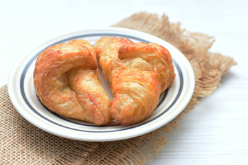 Small butter croissant, accompanied by blackberry jam