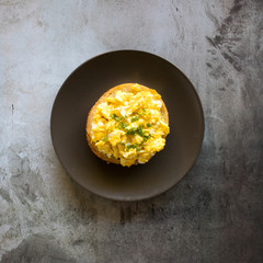 Scraambled Egg Bagel on a Concrete Background with Room for Copy