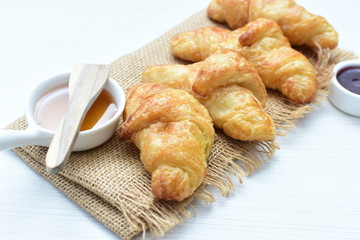 Small butter croissant, accompanied by honey