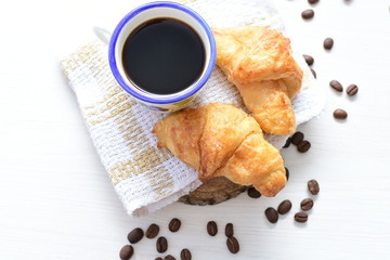 Small butter croissant, accompanied by coffee