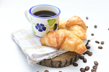 Small butter croissant, accompanied by coffee