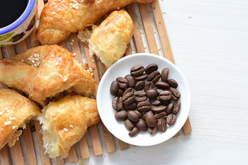 Small butter croissant, accompanied by coffee