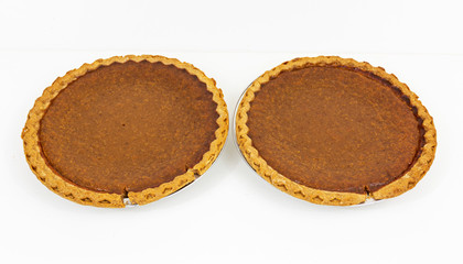 Two pumpkin pies with a white background © coachwood