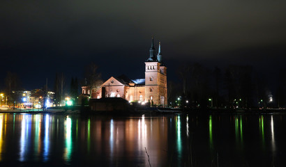 Fototapeta na wymiar Church at night by the river