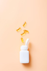 Fish oil vitamin capsules on light color background