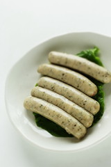 Boiled pork and herbal sausage on dish