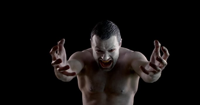 emotional actor with painted face expresses anger and spite