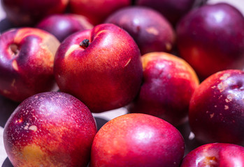 Fresh ripe nectarines at the market; background.