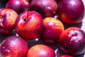 Fresh ripe nectarines at the market; background.