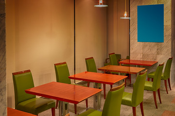 Line of Green Leather Chairs and Tables Located Inside of The Dining Room.