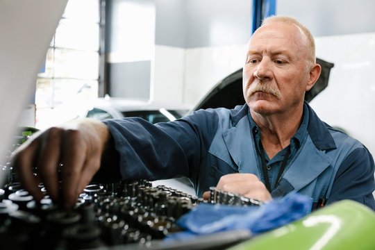 Mechanic looking in toolbox in automobile workshop