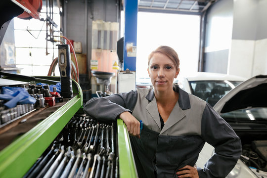 Portrait of female mechanic in automobile workshop