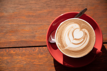 Top view of hot mocha latte art on wooden table.