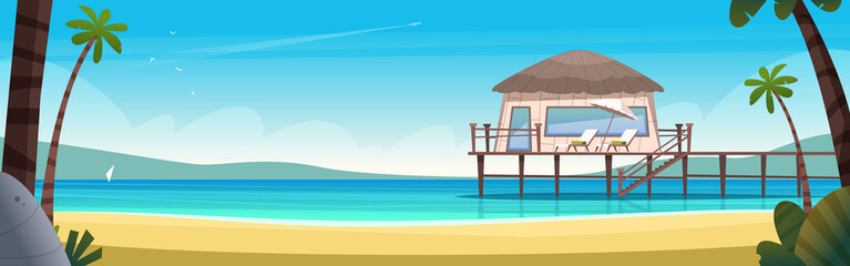 Hotel bungalow on a blue clear and calm sea. Summer vacation concept. Private house on a secluded sea beach with pier
