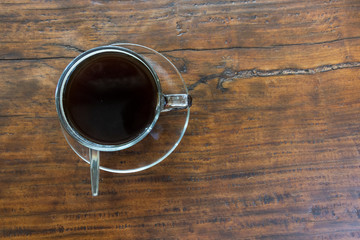 A coffee cup on a brown wooden table