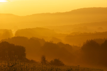 hazy golden sunrise in the mountains