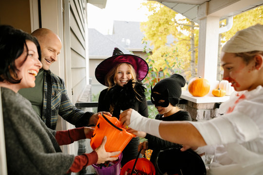 Children trick or treating their parents on Halloween
