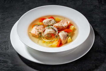 Meat soup in white plate close-up side view