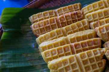 Many honeycomb sweets are placed on banana leaves.