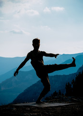 Fototapeta na wymiar Silhouette slim hip-hop style man jumping dancing