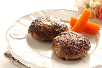 Homemade  hamburger patty and carrot for comfort food