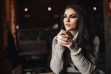 Beautiful woman drinking coffee sitting in a cafe.