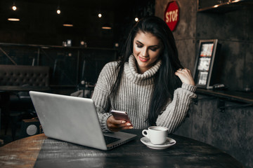 Beautiful woman working with laptop in a cafe.