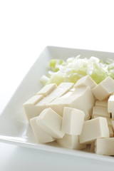 Chinese cooking, tofu and chopped scallion on plate