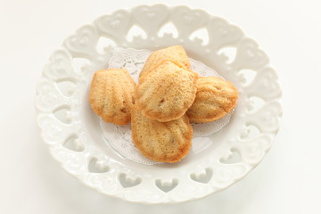 French confectionery, Madeleine cake on dish with copy space 