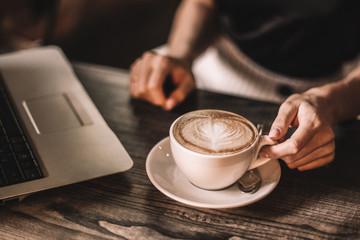 Beautiful woman drinking coffee sitting in a cafe.