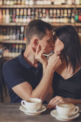Loving couple hugging in the cafe.