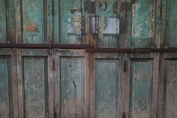 shabby wooden folding door leaving paint