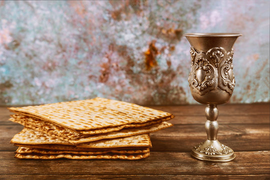 Matzos bread with kiddush cup of wine. Jewish pesah holiday.