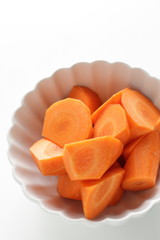 Chopped carrot in white bowl with copy space 