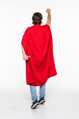 Portrait of man wearing bright super look outfit mantle isolated over light white background