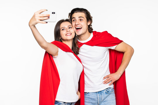Young couple hero in red cout take selfie on the phone isolated on white background