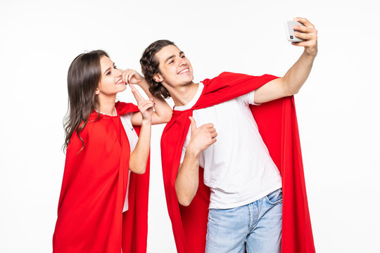 Young couple hero in red cout take selfie on the phone isolated on white background