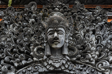 The traditional Balinese stone statue decorated in Pura Taman Ayun the royal temple of Mengwi empire in Badung Regency, Bali, Indonesia.