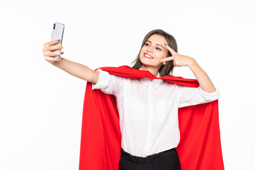 Naklejka premium Superhero Woman. Young and beautiful woman in red cout take selfie on the phone isolated on white background